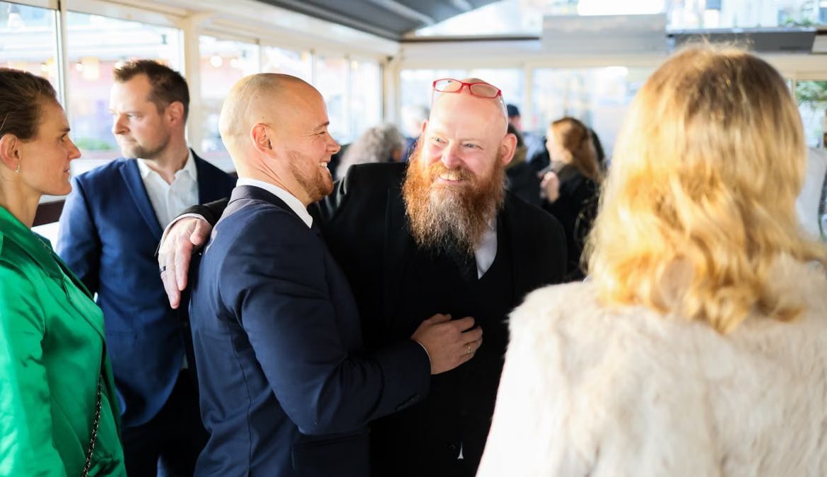 Candid scene of business professionals enjoying a jovial moment together indoors.